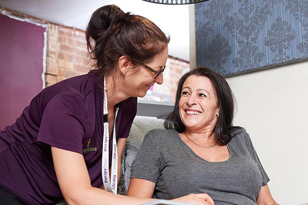 Middle-aged woman smiles at her therapist