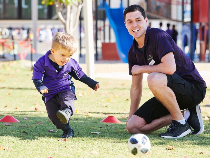 Therapist with ball kicking ball