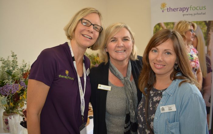 three women smile at camera