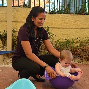 Therapist holds toddler in upturned plastic shell