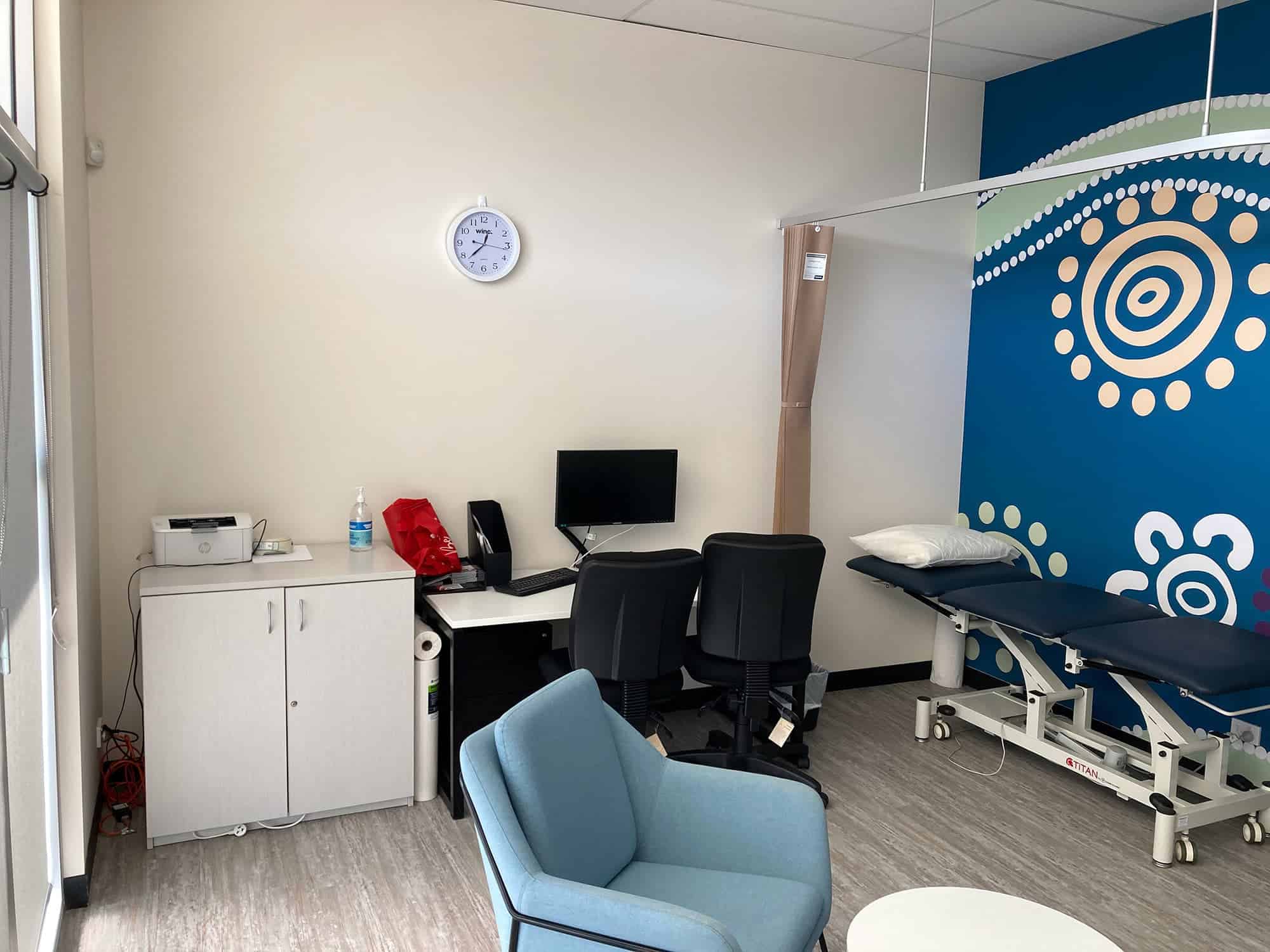 Therapy room with bed, chairs and computer