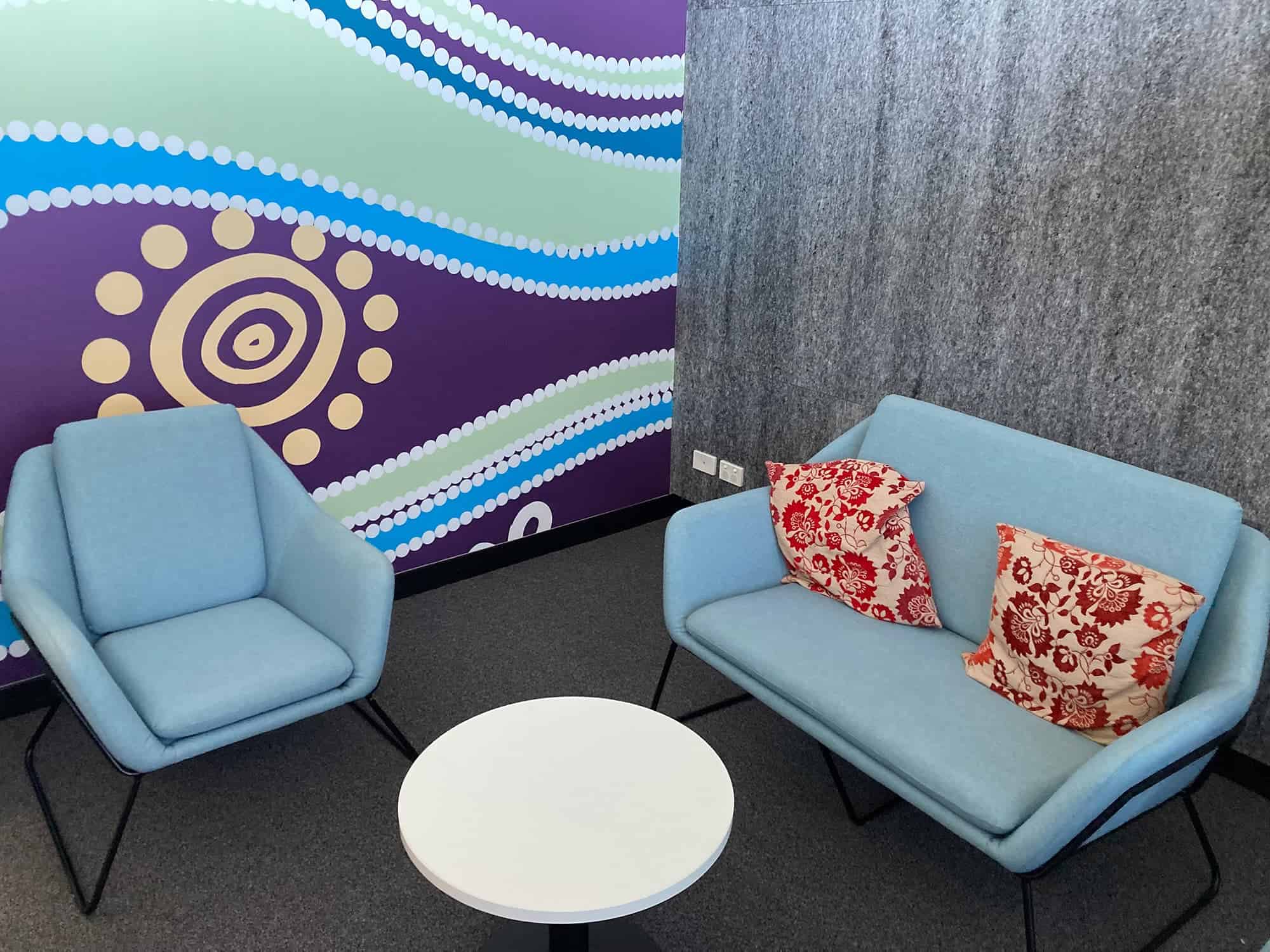 two comfortable blue chairs and a white round table