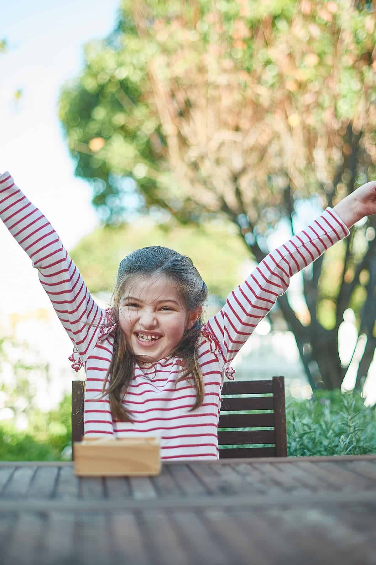 A girl raising her hands in the air