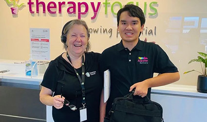 Alaister stands with Jillian in Therapy Focus reception