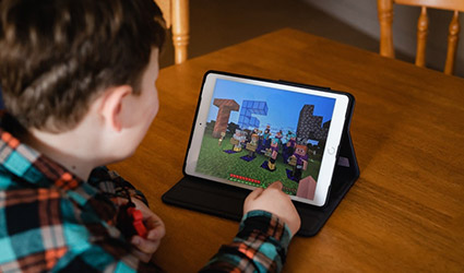 Customer engaging in Minecraft on iPad