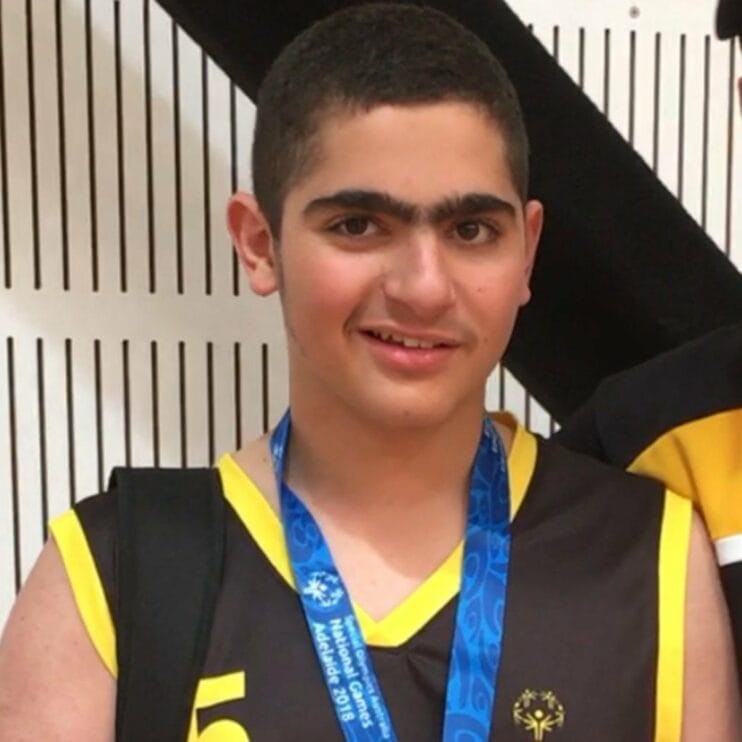 close up of young man winning a medal
