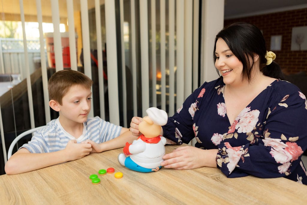 Mother and son playing with a toy pig