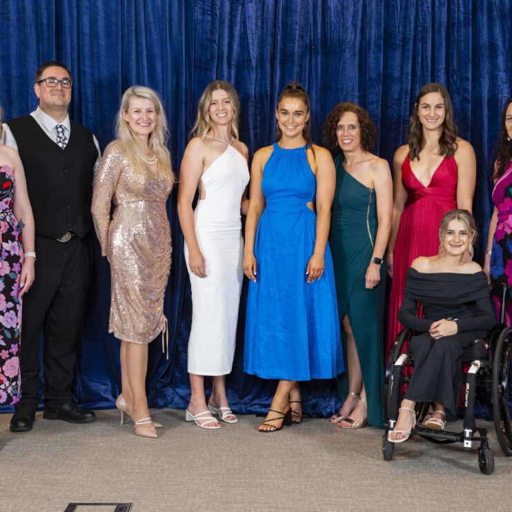 Members of the Therapy Focus team pose together in front of a blue backdrop.